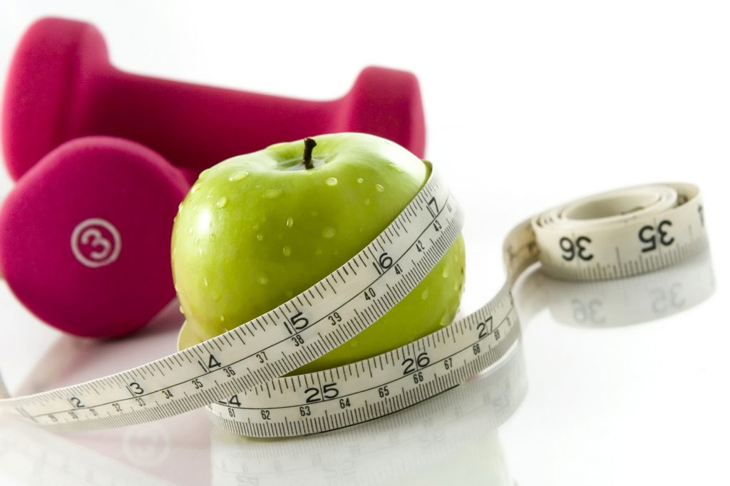An apple, weights, and a measuring string